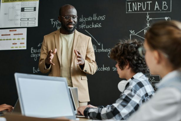 Teacher explaining the work of computer system